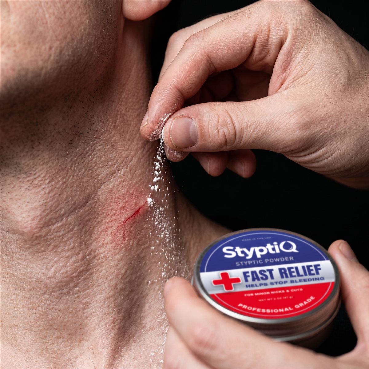 Applying a pinch of StyptiQ styptic powder to a shaving cut on the neck